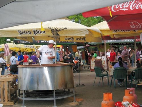 Picture 25 – . . . with the colorful goings-on and one of the many gigantic bean-soup kettles . . .